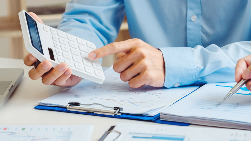 Man holding a calculator